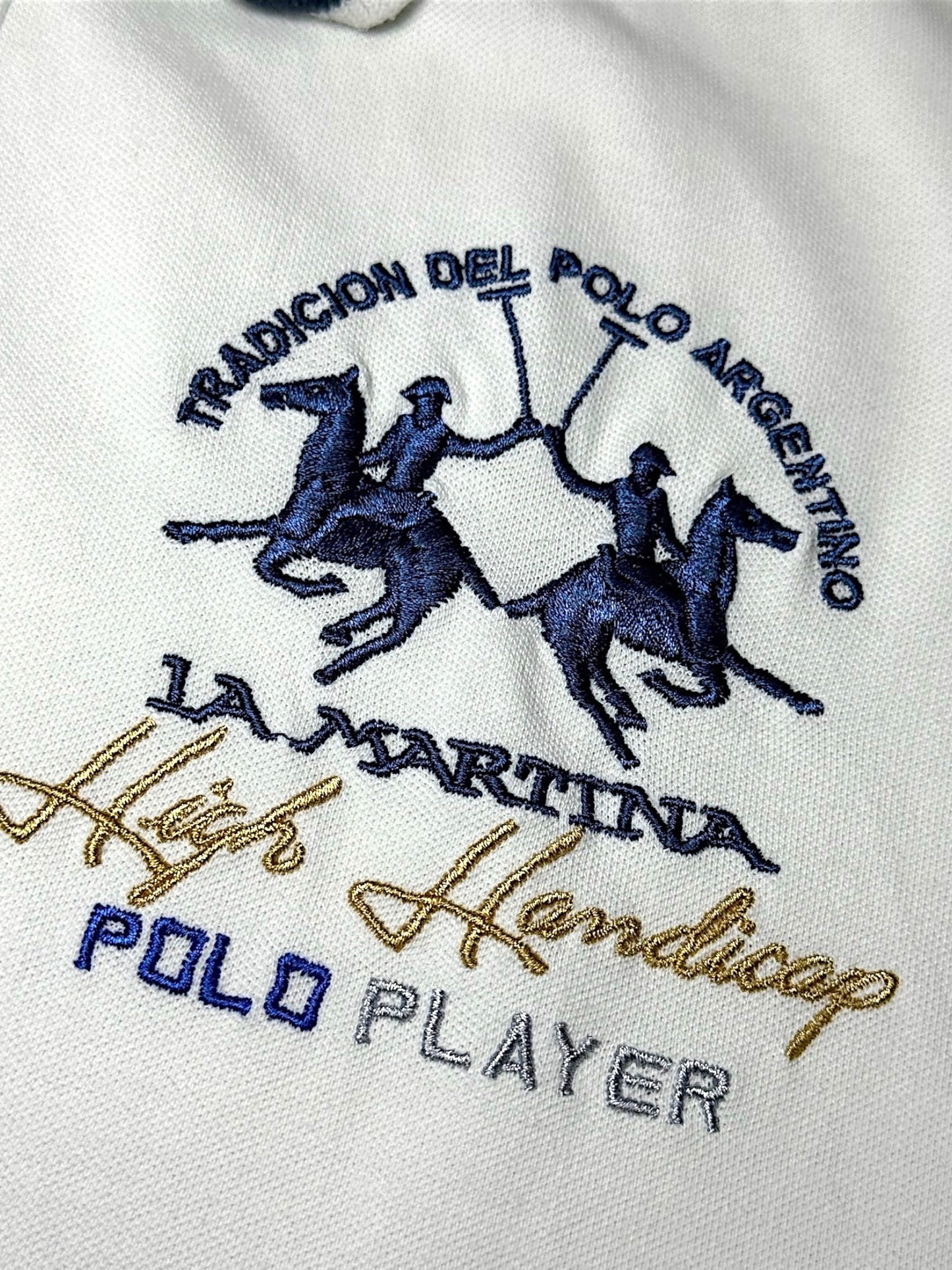 XTENDED white cotton polo shirt with blue and gold embroidered La Martina logo and text.