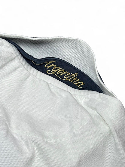 XTENDED vintage white polo shirt with navy collar and gold embroidered "Argentina" detail. Cotton pique fabric.