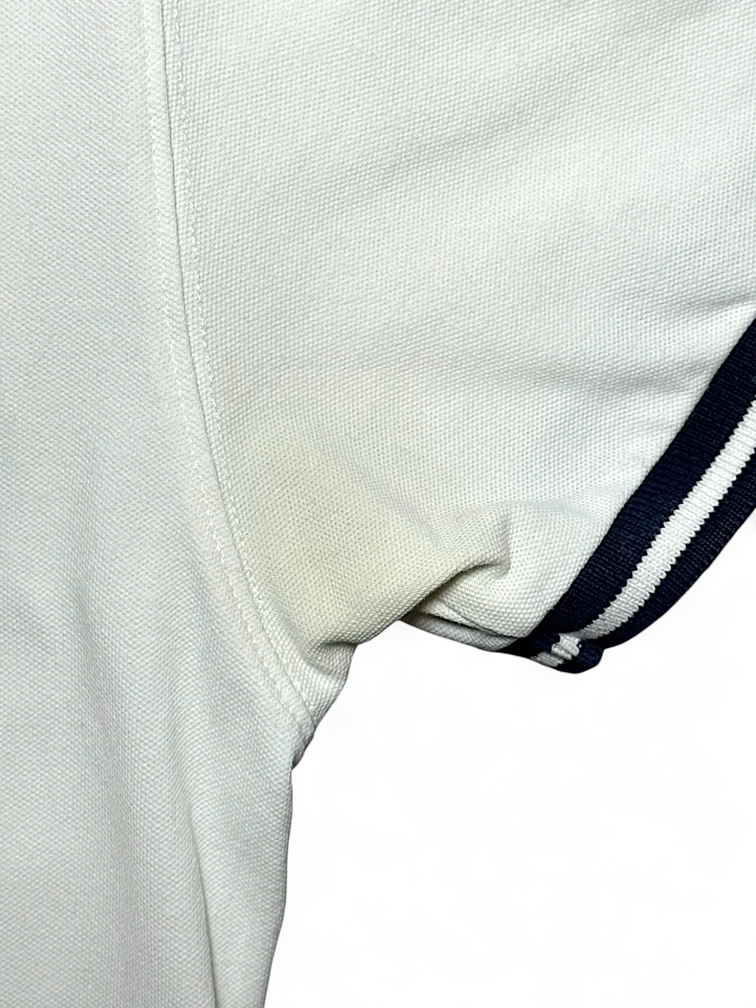 XTENDED vintage white cotton polo shirt with navy striped sleeves and a faint yellow stain under the arm.