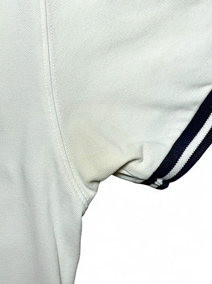 XTENDED vintage white cotton polo shirt with navy striped sleeves and a faint yellow stain under the arm.