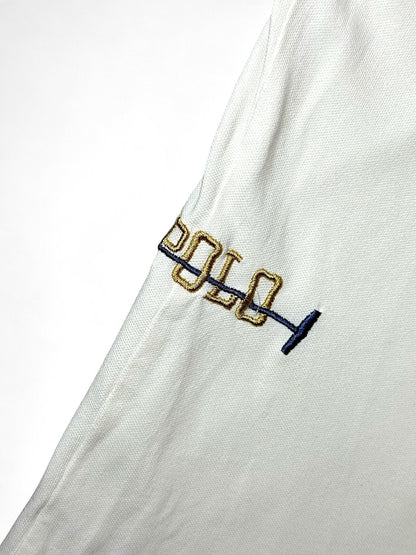 XTENDED white cotton polo shirt with embroidered gold and blue 'polo' text and mallet detail.