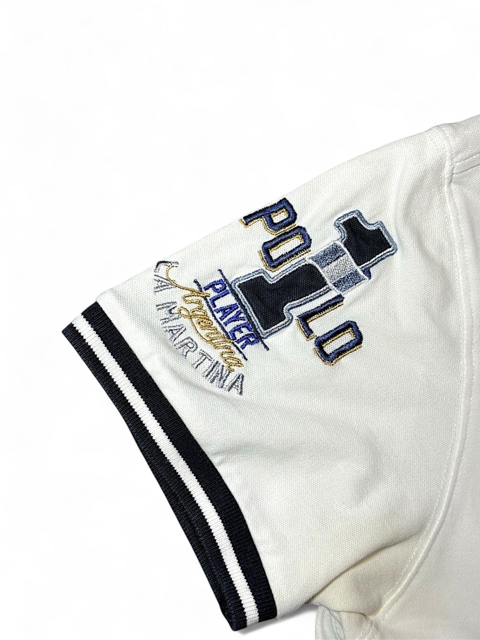 XTENDED vintage white cotton polo shirt with navy and gold embroidered 'Player Polo La Martina' logo on sleeve and striped cuffs.